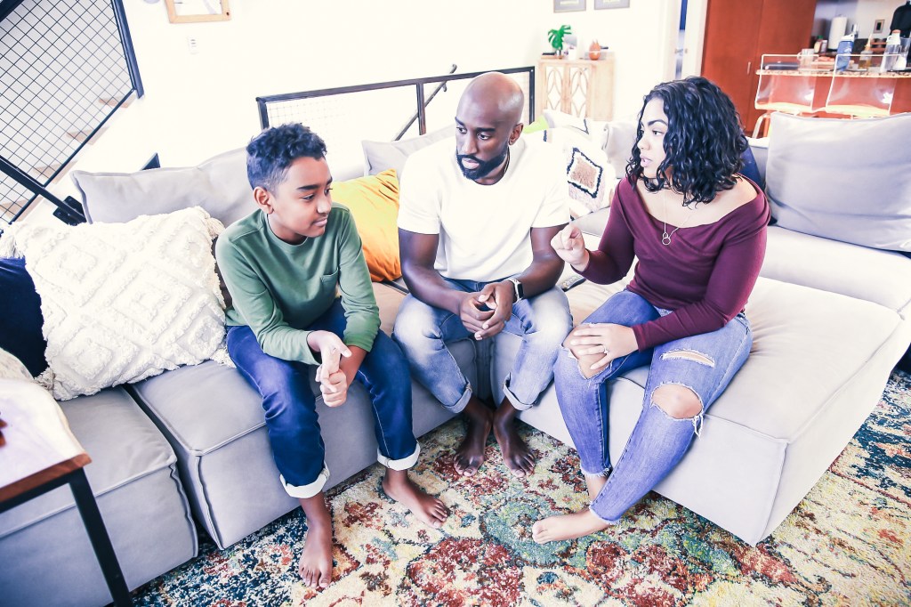 Mom and Dad talking with child.