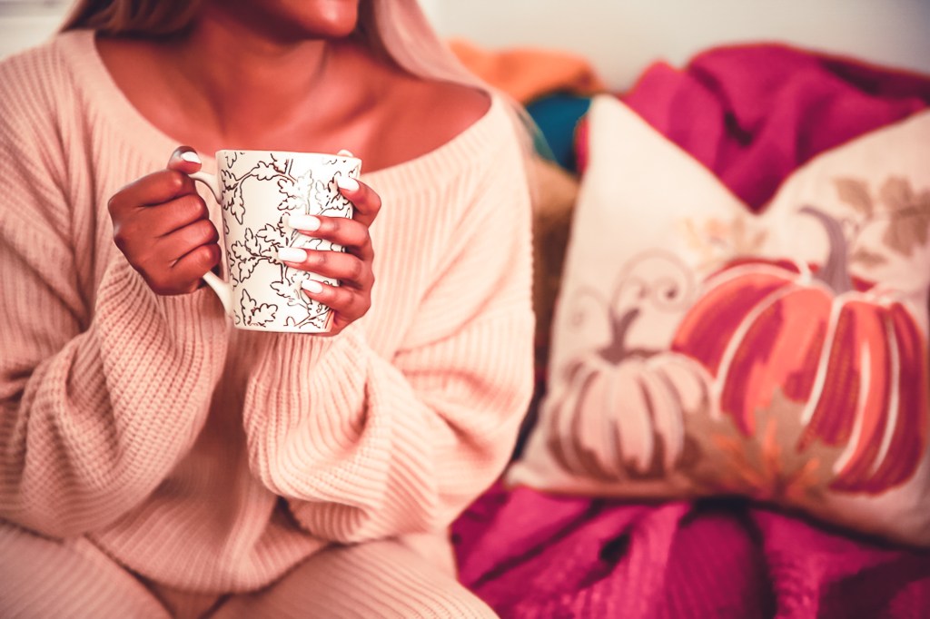 Picture of a woman holding coffee mug.